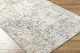 Close-up of Kasim Textured Rug with Fringes. Light gray, white, gold, and brown abstract pattern. Contemporary style. Corner