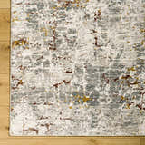Close-up of the Kasim Textured Rug in light gray, showcasing its contemporary pattern and soft texture on a wood floor. Corner