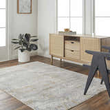 Living room scene with a cloud gray Mila Textured Rug, wood floors, and a light wood cabinet. Roomscene-Rectangle