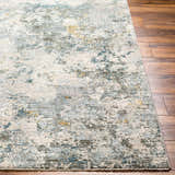Close-up of the Pizi Textured Rug. Features a contemporary abstract design in dusty sage, ink blue, and light gray. Front