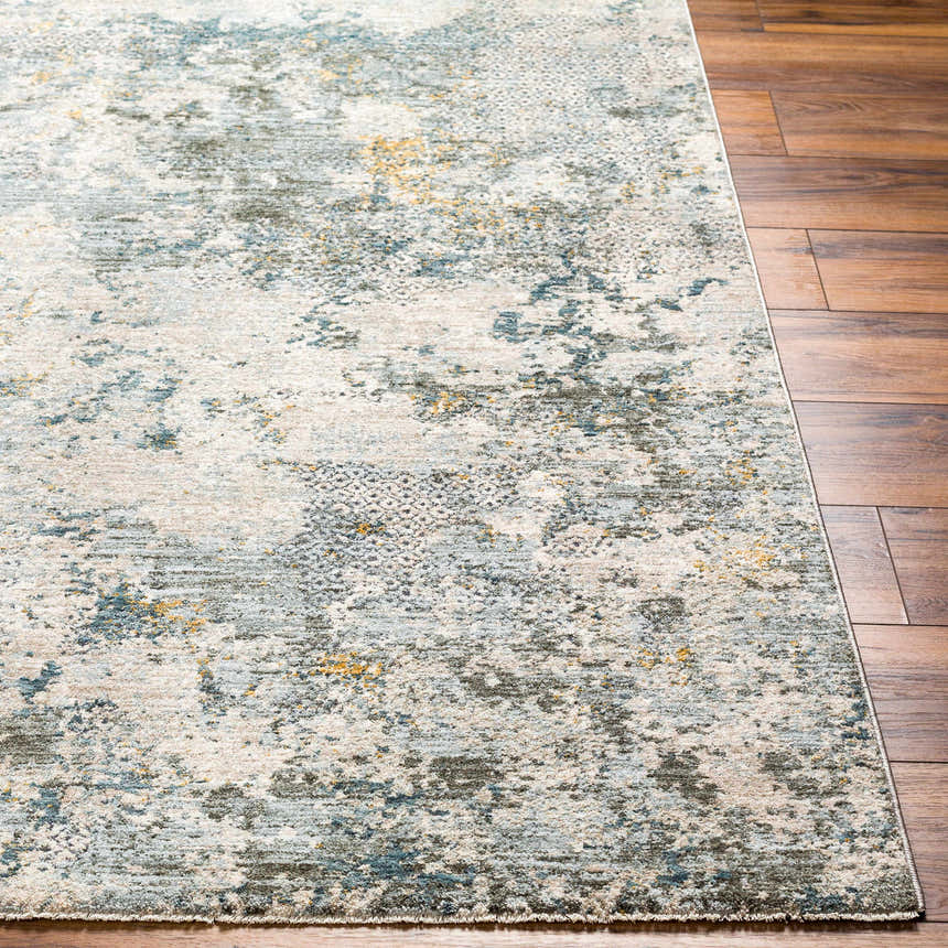 Close-up of the Pizi Textured Rug. Features a contemporary abstract design in dusty sage, ink blue, and light gray. Front