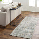 Living room scene with a Pizi Textured Rug in light gray, blue, and mustard tones on a wood floor. Roomscene-Runner