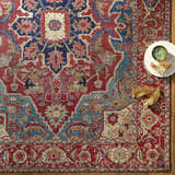 Close-up of the Seattle Area Rug in beige, burnt orange, and blue with a traditional floral pattern. Styleshot