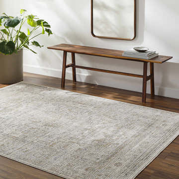 Entryway with a Kazou Gray Medallion Area Rug, wood bench, mirror, and potted plant creating a welcoming, neutral-toned space. Roomscene-Rectangle