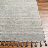 Close-up of the Anaya Beige & Teal Area Rug showing woven texture and tassels on wood floor. Front