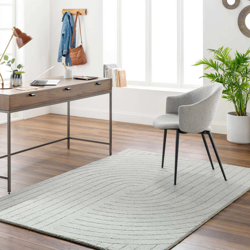 Home office with wood desk, gray chair, and light gray Ayumi Area Rug with subtle geometric pattern. Roomscene-Rectangle