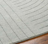 Close up of the hand loomed Ayumi Area Rug. Neutral gray wool with a subtle, contemporary line pattern. Texture