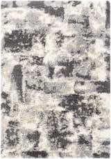 Close-up of the Selcuklu Area Rug, a shag rug in black, cream, light beige, and light gray. Contemporary style. Design-Rectangle-537