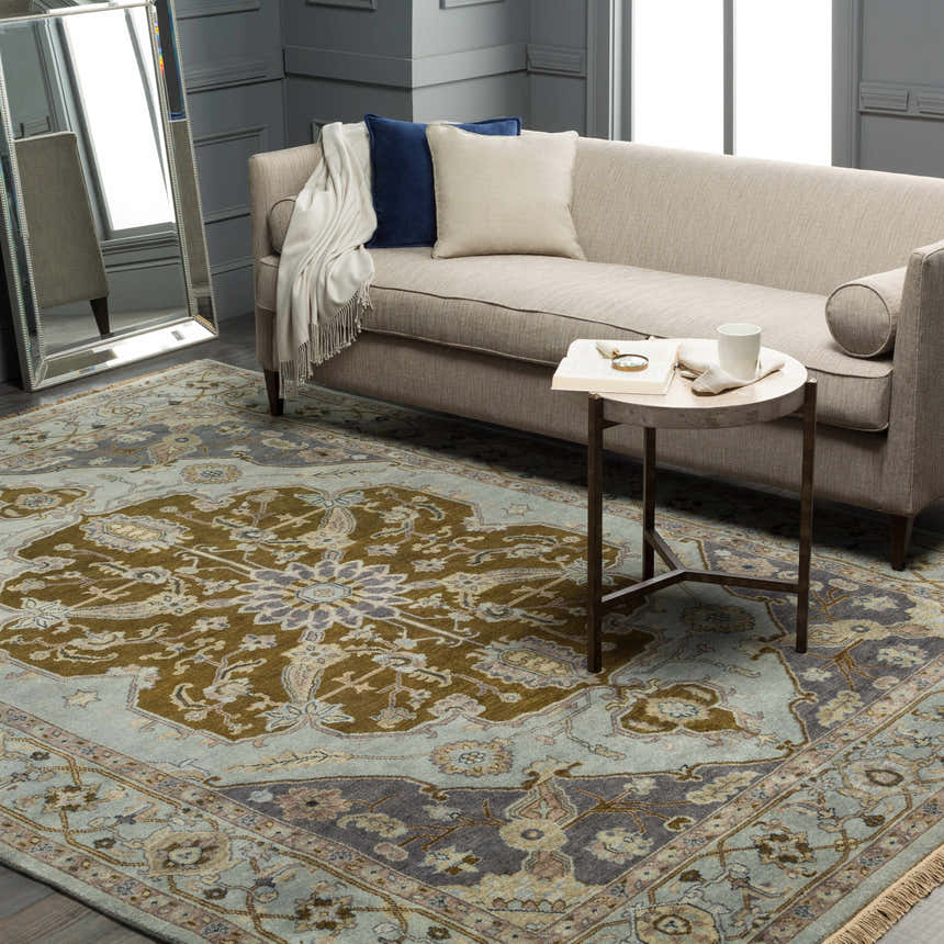 Styled room featuring the Senath Area Rug, a hand-knotted wool rug in ivory, mauve, navy, olive, slate, and tan. Roomscene-Rectangle