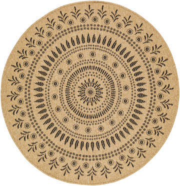 Close-up of the Beata Round Faux Jute Rug. Camel color with a charcoal floral medallion pattern. Farmhouse style. Design-Round-53