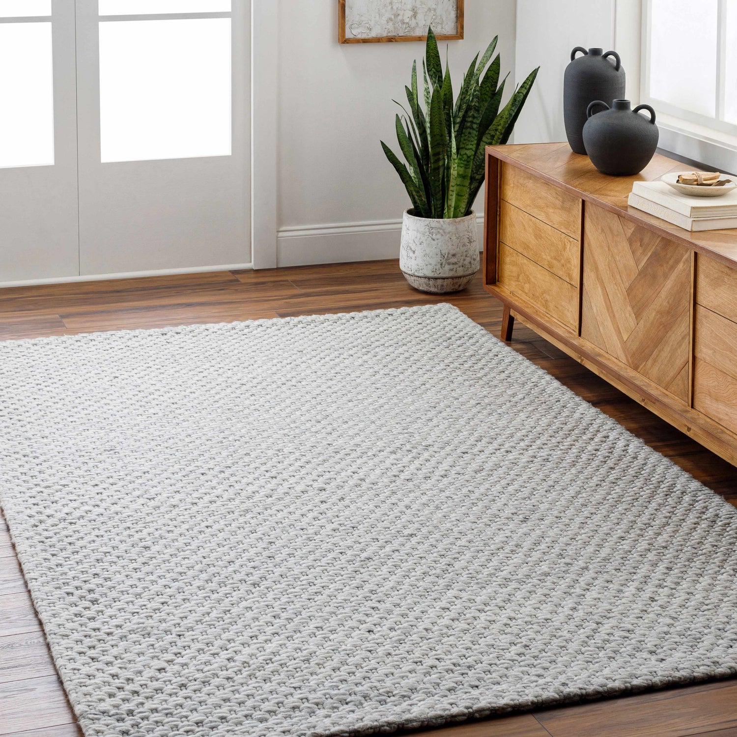 Entryway with Kassa Gray Hand Woven Area Rug, wood floors, console table, plant, and neutral decor. Roomscene-Rectangle