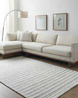 Living room scene with a beige sectional sofa and a striped Laleh Gray Area Rug. Roomscene-Rectangle