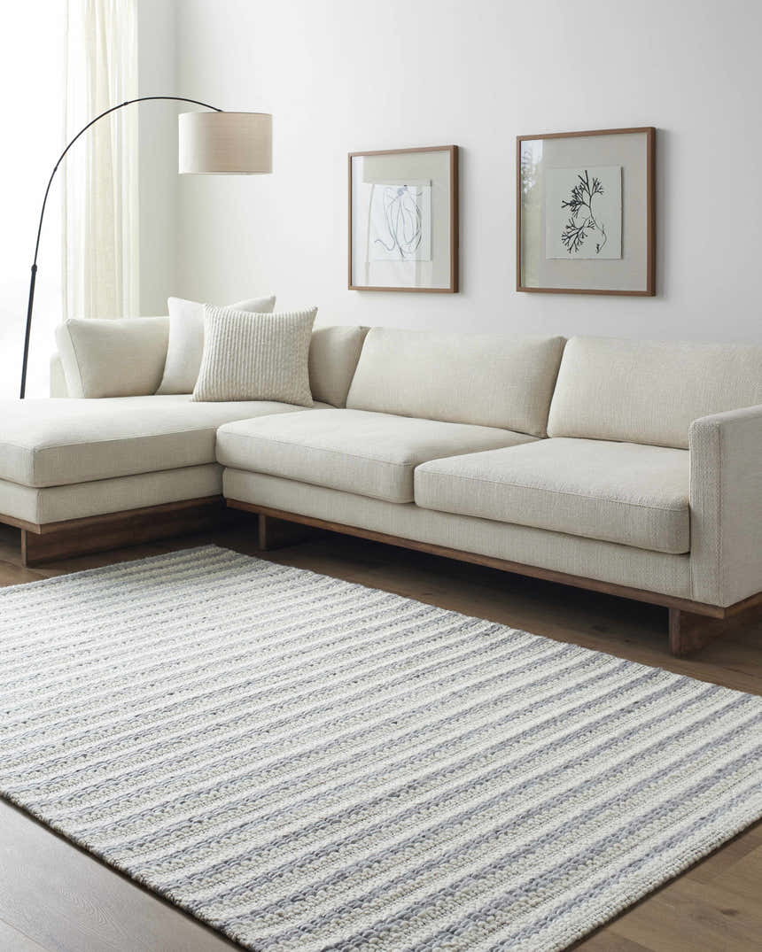 Living room scene with a beige sectional sofa and a striped Laleh Gray Area Rug. Roomscene-Rectangle