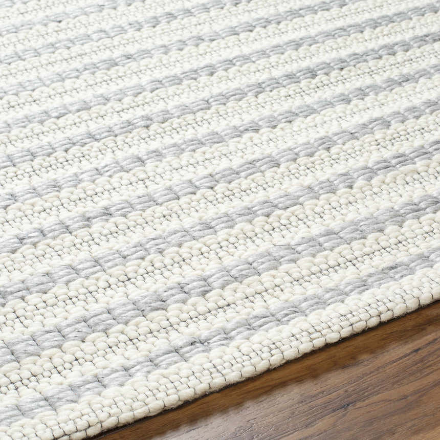 Close-up of the hand woven Laleh Gray Area Rug showing beige and rose cream stripes and wool texture. Texture