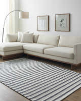 Living room with a cream sectional sofa and Laleh Cream & Gray Area Rug with bold stripes. Roomscene-Rectangle