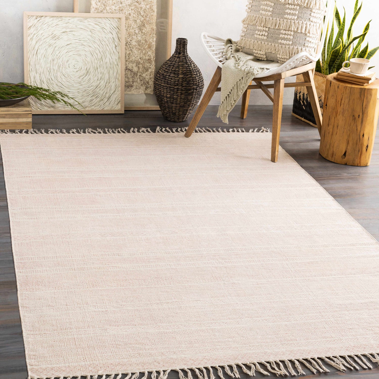 Bohemian living room scene with a peach Serena Area Rug, wood accents, and neutral decor. Roomscene-Rectangle