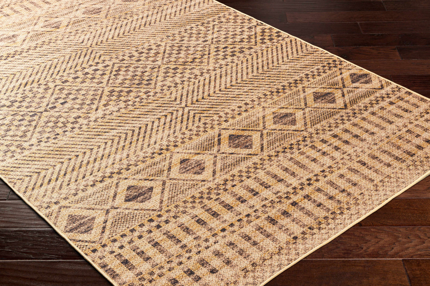 Close-up of the Ammar Washable Area Rug showcasing its camel, brown, and jute geometric pattern and machine-woven texture. Corner