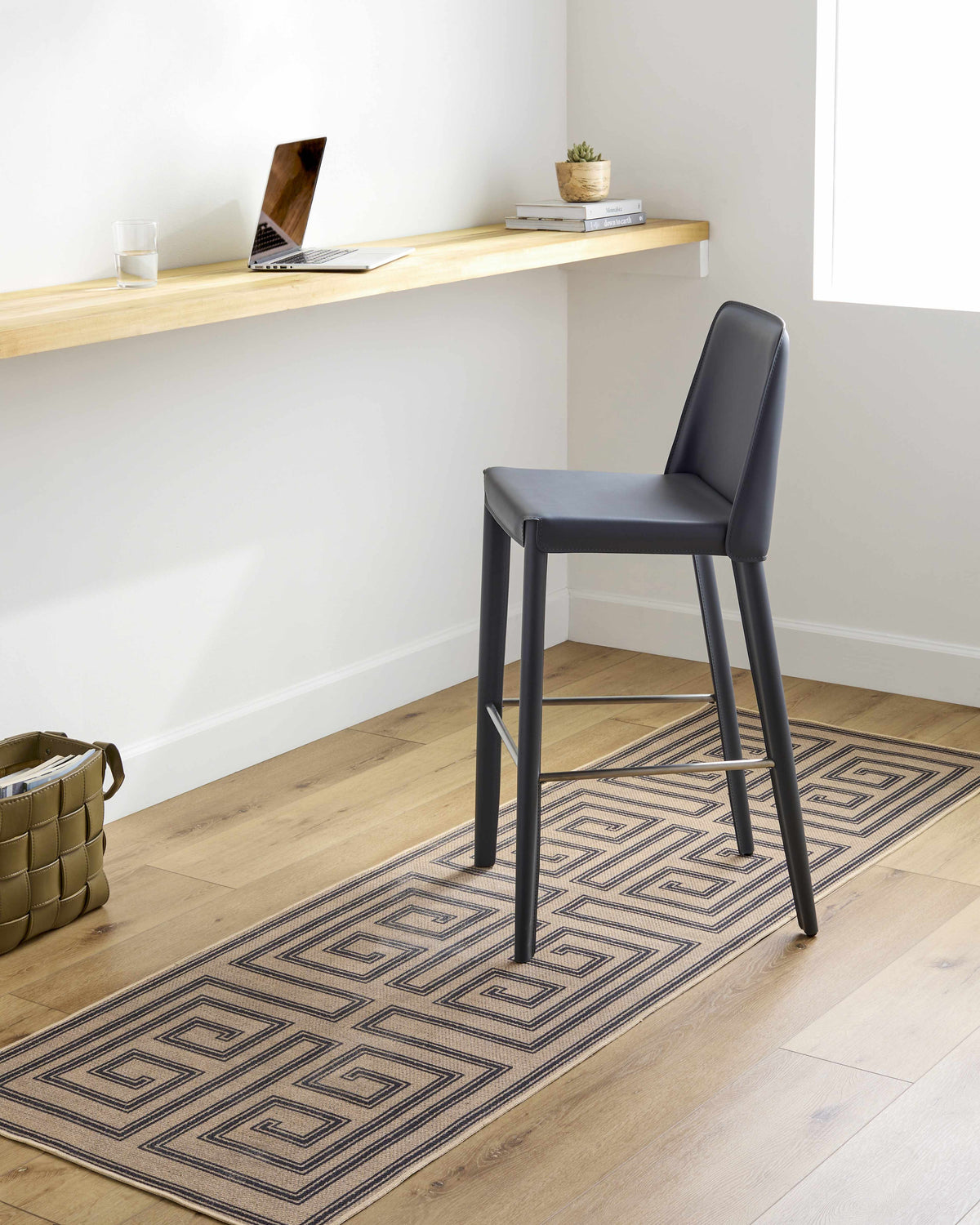 Home office with a Coty Washable Jutely Rug runner in natural jute and charcoal under a desk and gray chair. Roomscene-Runner