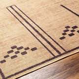 Close-up of the Fathi Washable Area Rug. Camel rug with dark brown stripes and geometric pattern. Farmhouse style. Texture