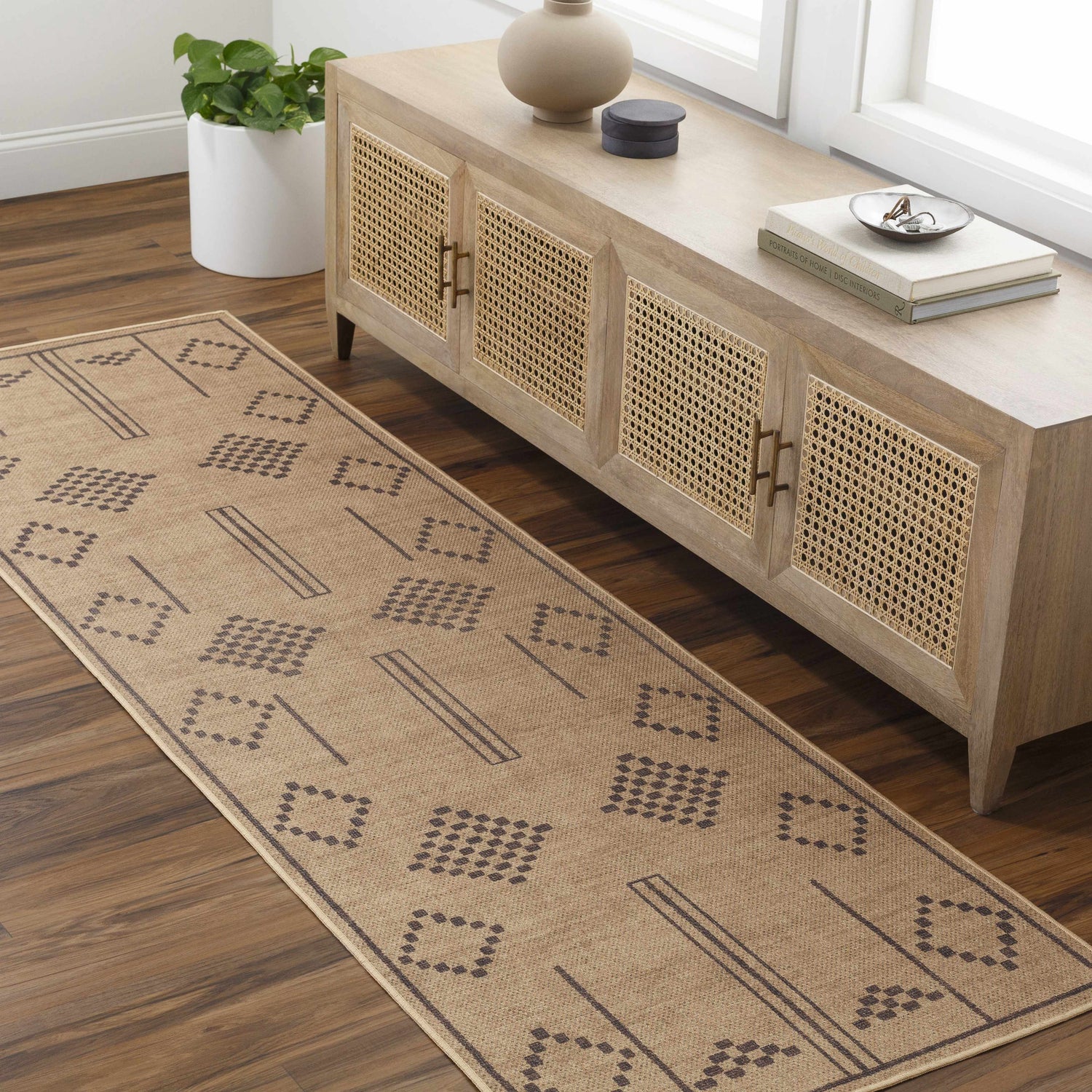 Entryway with camel Fathi Washable Area Rug runner, wood floors, and a natural wood console table. Roomscene-Runner