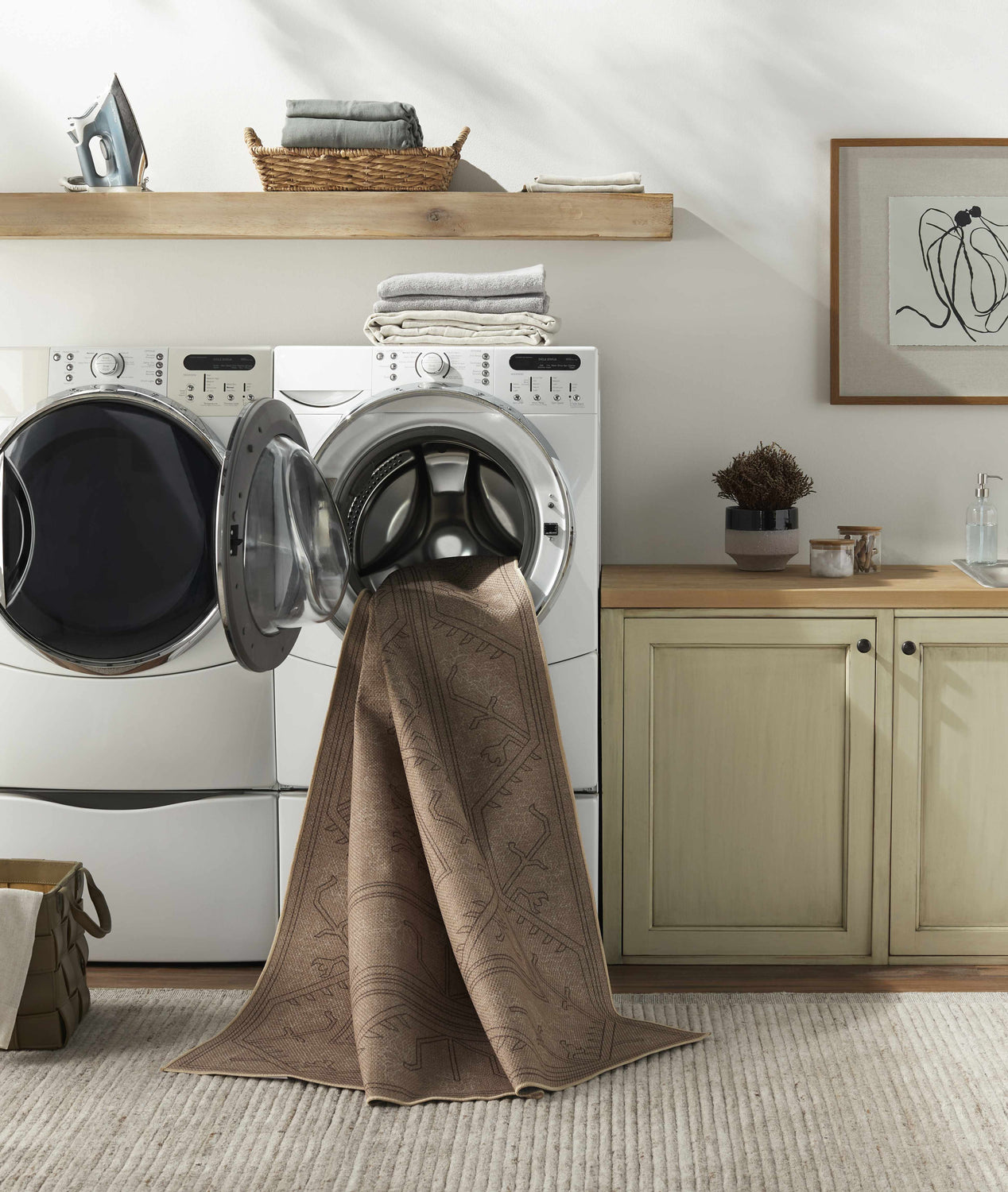 Farmhouse laundry room with Naja Washable Area Rug partially in the washing machine, showcasing its easy cleaning. Washing-Machine