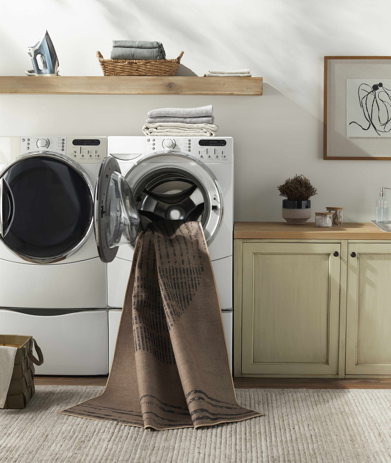 Laundry room scene with Yuki Washable Area Rug in a washing machine. The rug is camel and brown. Neutral tones and farmhouse style. Washing-Machine