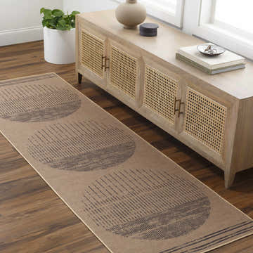 Entryway with a camel Yuki Washable Area Rug runner featuring a geometric circle design, paired with a light wood console table. Roomscene-Runner