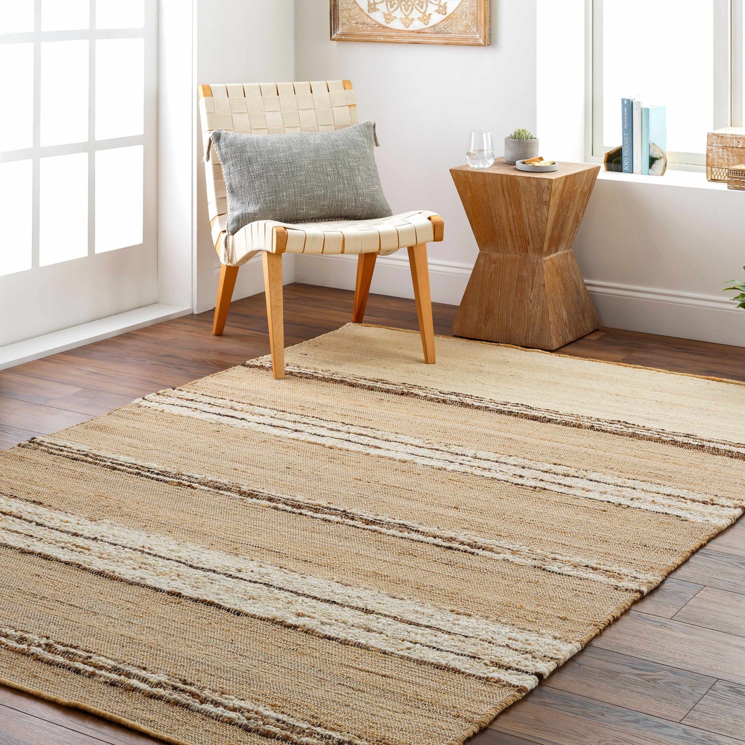 Living room scene with a beige Arnie Area Rug, woven chair, and wood side table. Roomscene-Rectangle