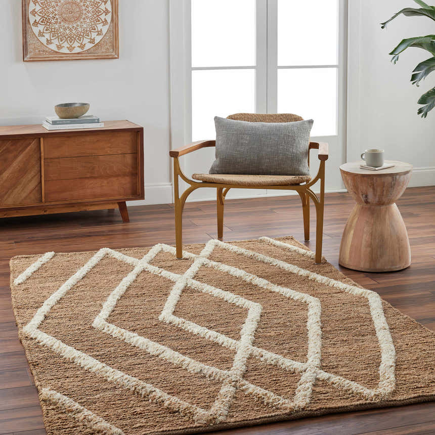 Living room scene with Allie Textured Jute Rug, wood cabinet, chair, and side table. Farmhouse style with natural tones. Roomscene-Rectangle