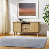 Living room scene with a gray Nari Area Rug, wood floors, and a mid-century modern cabinet. Roomscene-Rectangle