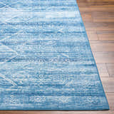 Close-up of the Blake Arctic Sky Washable Area Rug showing its blue hues and traditional-inspired geometric pattern. Front