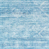 Close-up of Blake Arctic Sky Washable Area Rug. Features a geometric pattern in shades of blue, denim, and white. Swatch