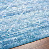 Close-up of the Blake Arctic Sky Washable Area Rug. Features a traditional, farmhouse design in arctic sky and white hues. Texture