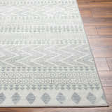 Close-up of the Danon Washable Area Rug in arctic stone and gray, featuring a geometric pattern on a wood floor. Front
