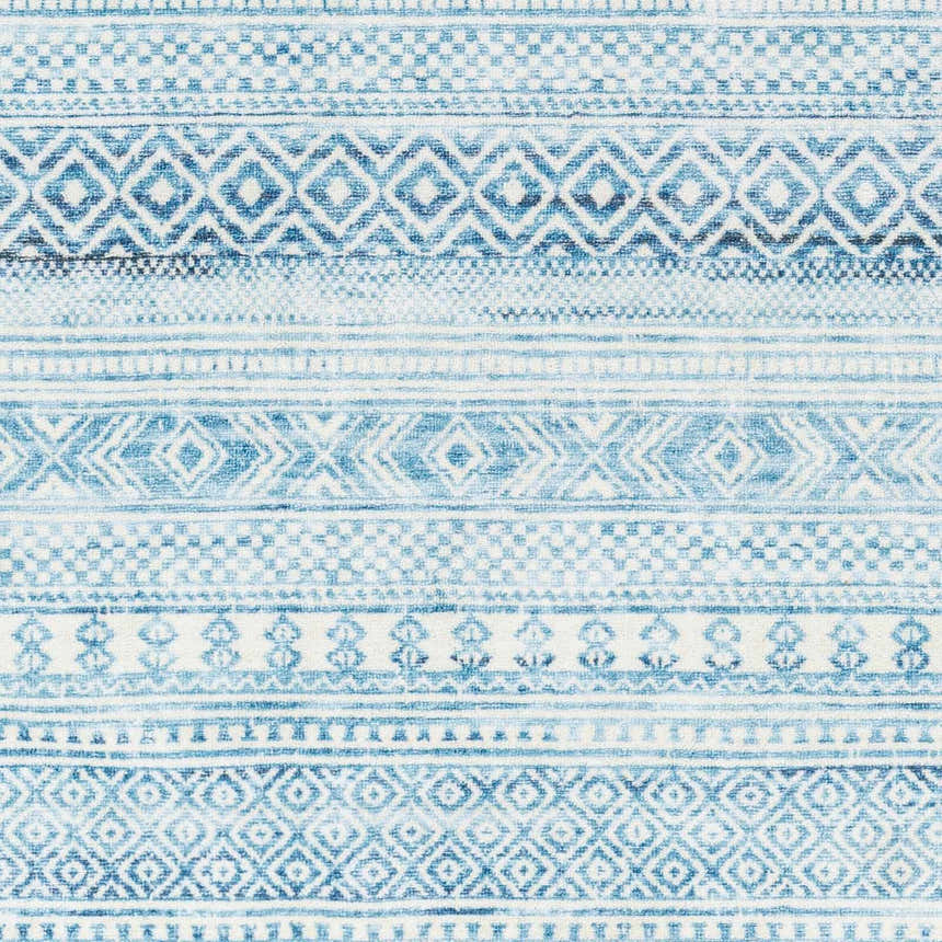 Close-up of Gizeh Arctic Stone Washable Area Rug. Features a farmhouse style geometric pattern in arctic stone, gray, and blue hues. Swatch