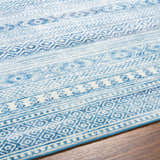 Close-up of the Gizeh Arctic Stone Washable Area Rug, featuring a geometric pattern in arctic stone, gray, and blue hues. Texture
