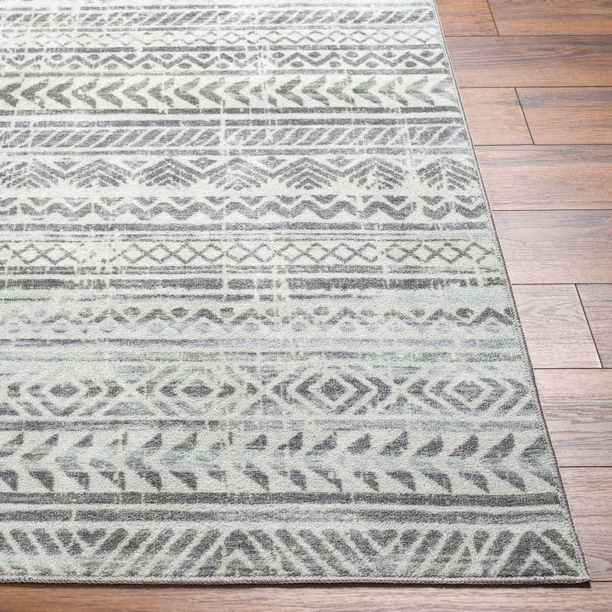 Close-up of the Ianna Light Gray Washable Area Rug showing its farmhouse style geometric pattern and soft polyester texture. Front