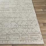 Close-up of Shortland Premium Area Rug in gray and ivory, featuring a geometric tribal pattern and hand-loomed texture. Front