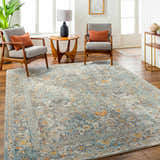 Living room scene with the Finn Silver Blue Area Rug, gray chairs, wood floors, and natural light. Roomscene-Rectangle
