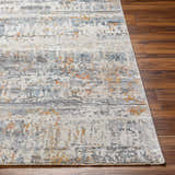 Close-up of Guoda Area Rug in driftwood, gray, and nutmeg on a wood floor. Contemporary style. Front