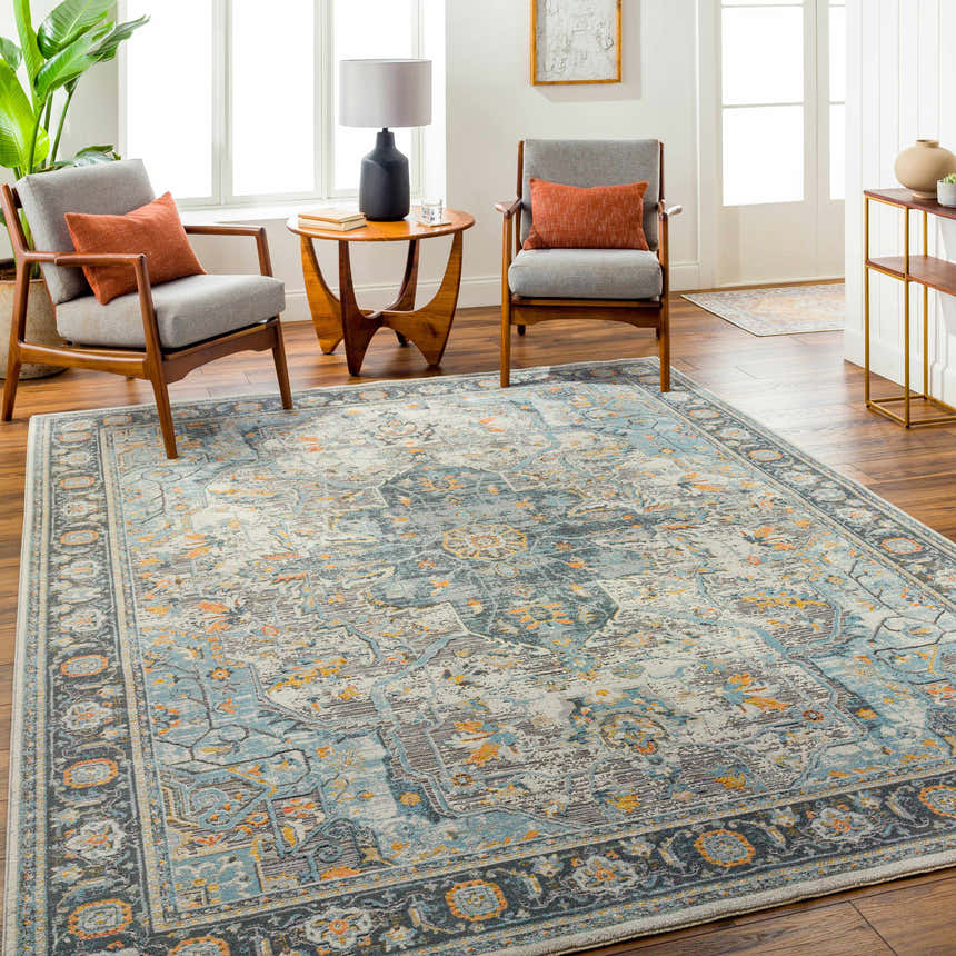 Living room scene with a gray and blue Hovan Area Rug, mid-century chairs, and wood floors. Roomscene-Rectangle