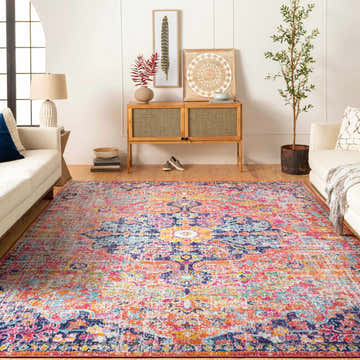 Living room with white sofas and a colorful bohemian Shueyville Area Rug in burgundy, orange, mustard, navy, teal, and white. Roomscene-Rectangle