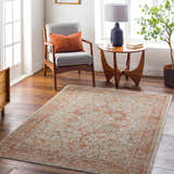 Living room scene with Cress Rust rug, gray chair, wood table, and warm, inviting decor. Roomscene-Rectangle