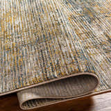 Close-up of the Osma Rich Textured Traditional Rug. Bone, driftwood, multi brown, taupe, and walnut colors. Fold
