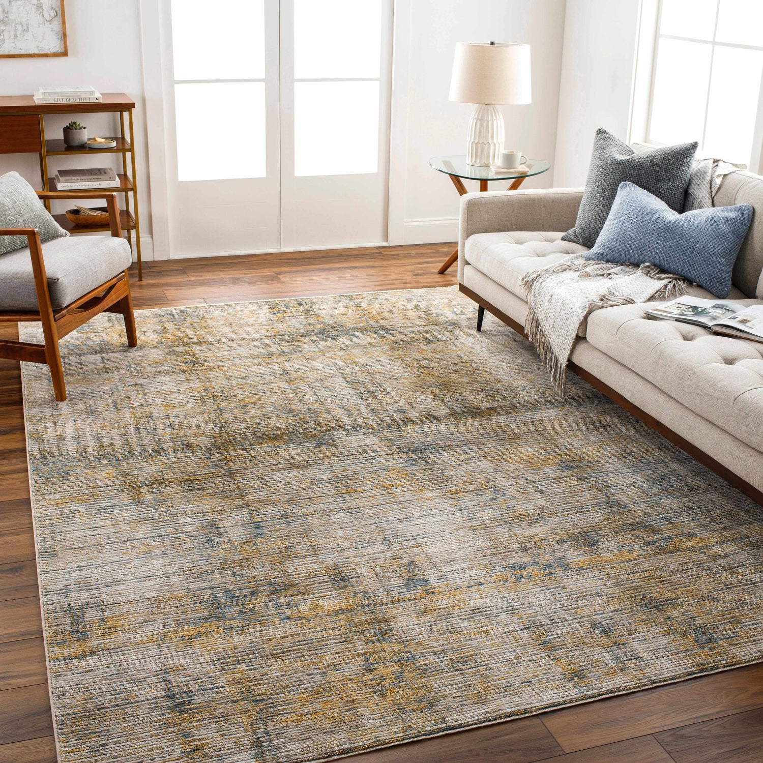 Living room scene with the Osma Rich Textured Traditional Rug in bone, driftwood, multi brown, taupe, and walnut colors. Roomscene-Rectangle