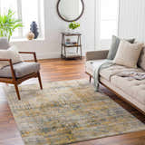 Living room scene with a bone sofa, gray chair, and the Osma Rich Textured Traditional Rug in driftwood and multi brown. Roomscene-Rectangle