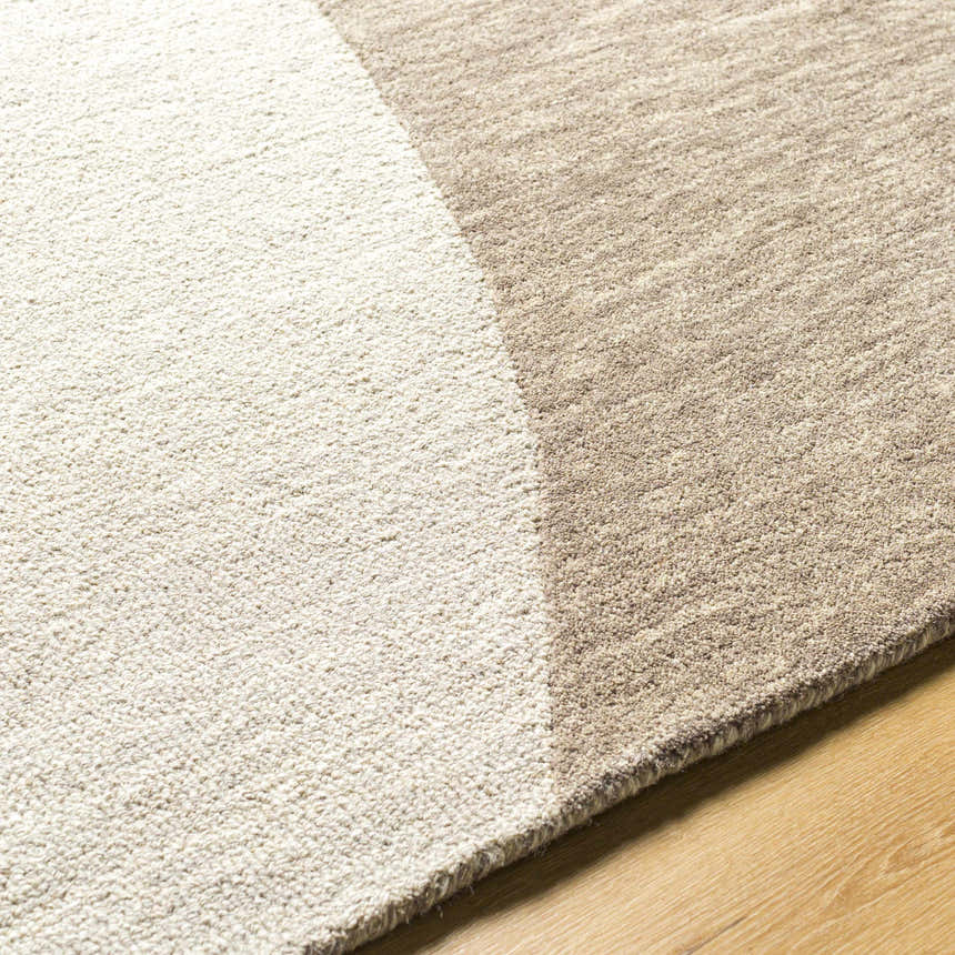 Close-up of the hand-tufted Cassiopeia Dark Brown & Beige Area Rug showing wool texture and contemporary design. Texture