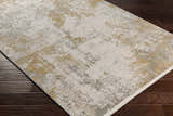Close-up of a Siirt Textured Luxe Rug in bone, faded driftwood, gray, and light brown on a dark wood floor. Corner
