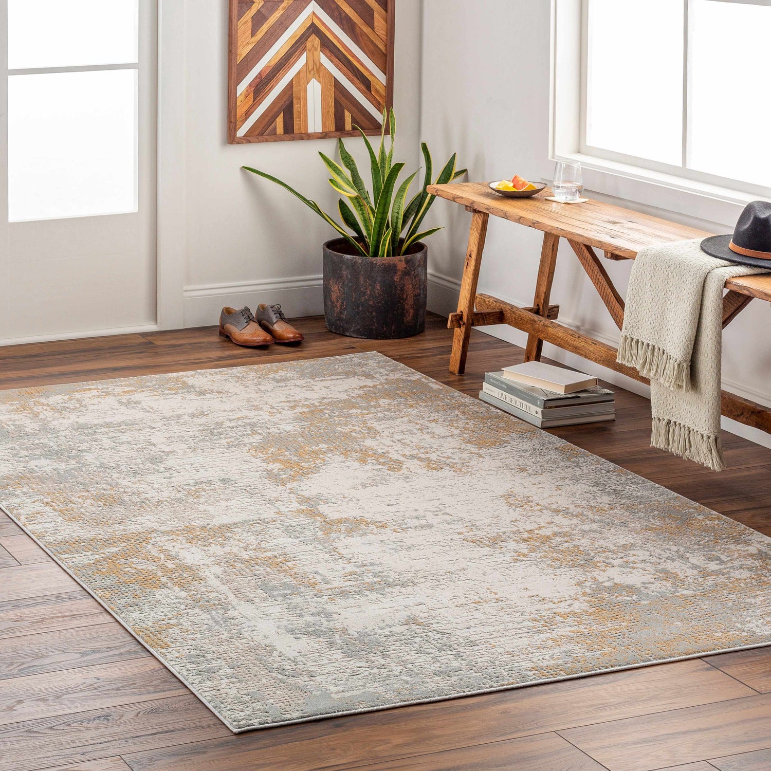 Entryway with Siirt Textured Luxe Rug in bone, faded driftwood, and gray. Rustic bench, wood art, and warm accents. Roomscene-Rectangle