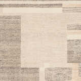 Close-up of the Fadri Area Rug. Hand-knotted wool rug with geometric beige, ivory, and taupe pattern. Swatch
